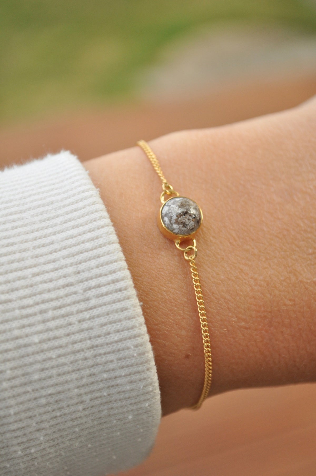 Gold memorial chain bracelet worn on the wrist